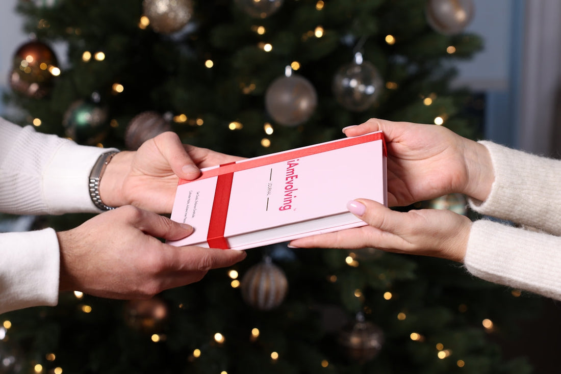Hands exchanging a gift with christmas tree background